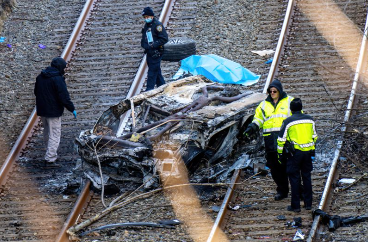 Two dead after speeding BMW veers of NYC Henry Hudson Parkway, lands on Amtrak tracks below and bursts into flames