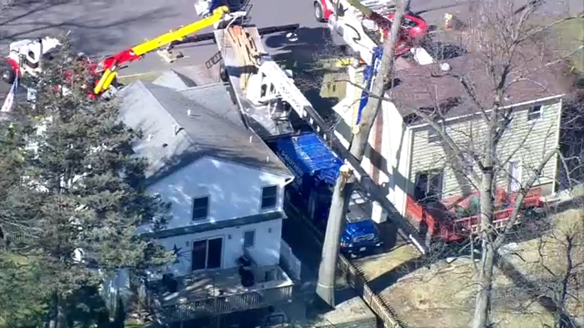 Photos show large construction crane collapsed, tangled in power wires in Cresskill, New Jersey